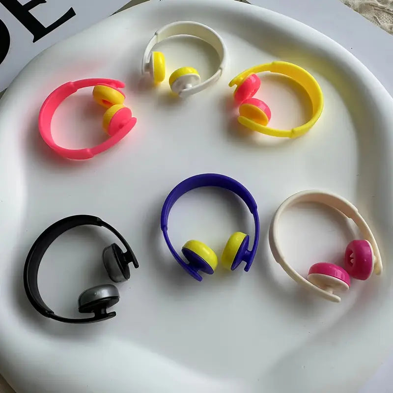 Colorful mini headphones on a white surface