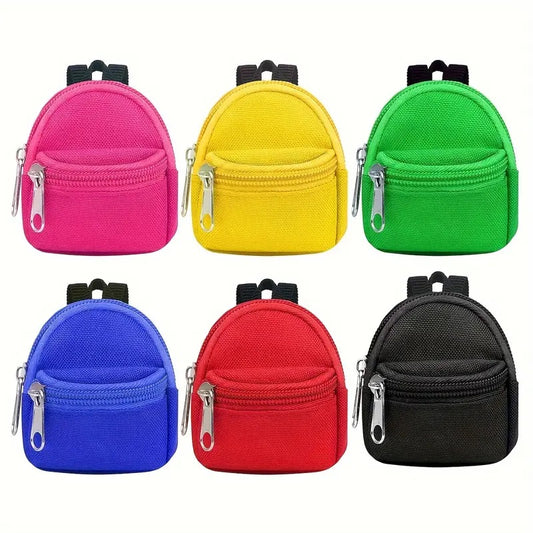 A collection of six colorful mini backpacks in pink, yellow, green, blue, red, and black, each with a front zipper pocket and adjustable straps.