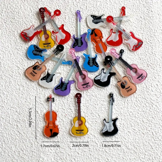 Collection of colorful miniature guitar-shaped items on a textured white background with measurements.
