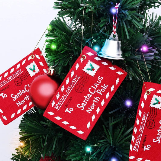 Red envelope ornaments labeled 'Special Delivery to Santa Claus North Pole' on a Christmas tree.