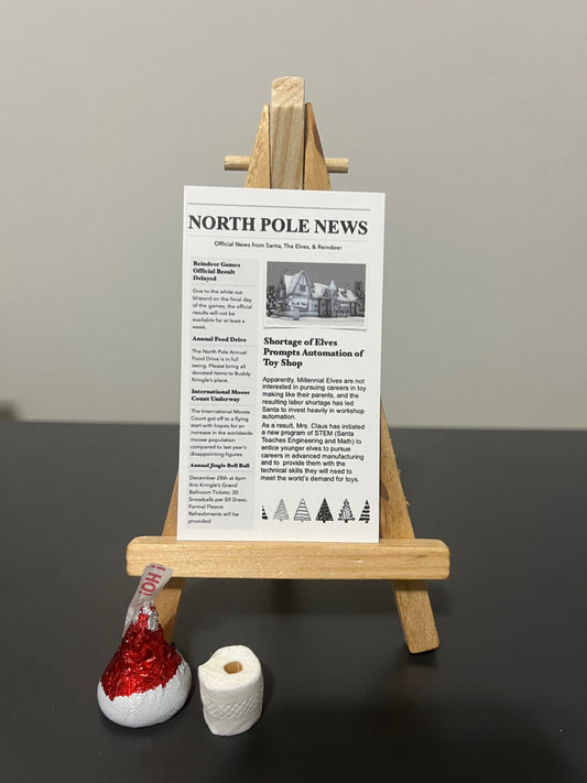 Elf Bathroom Prank Set with mini newspaper, toilet paper, and chocolate kiss